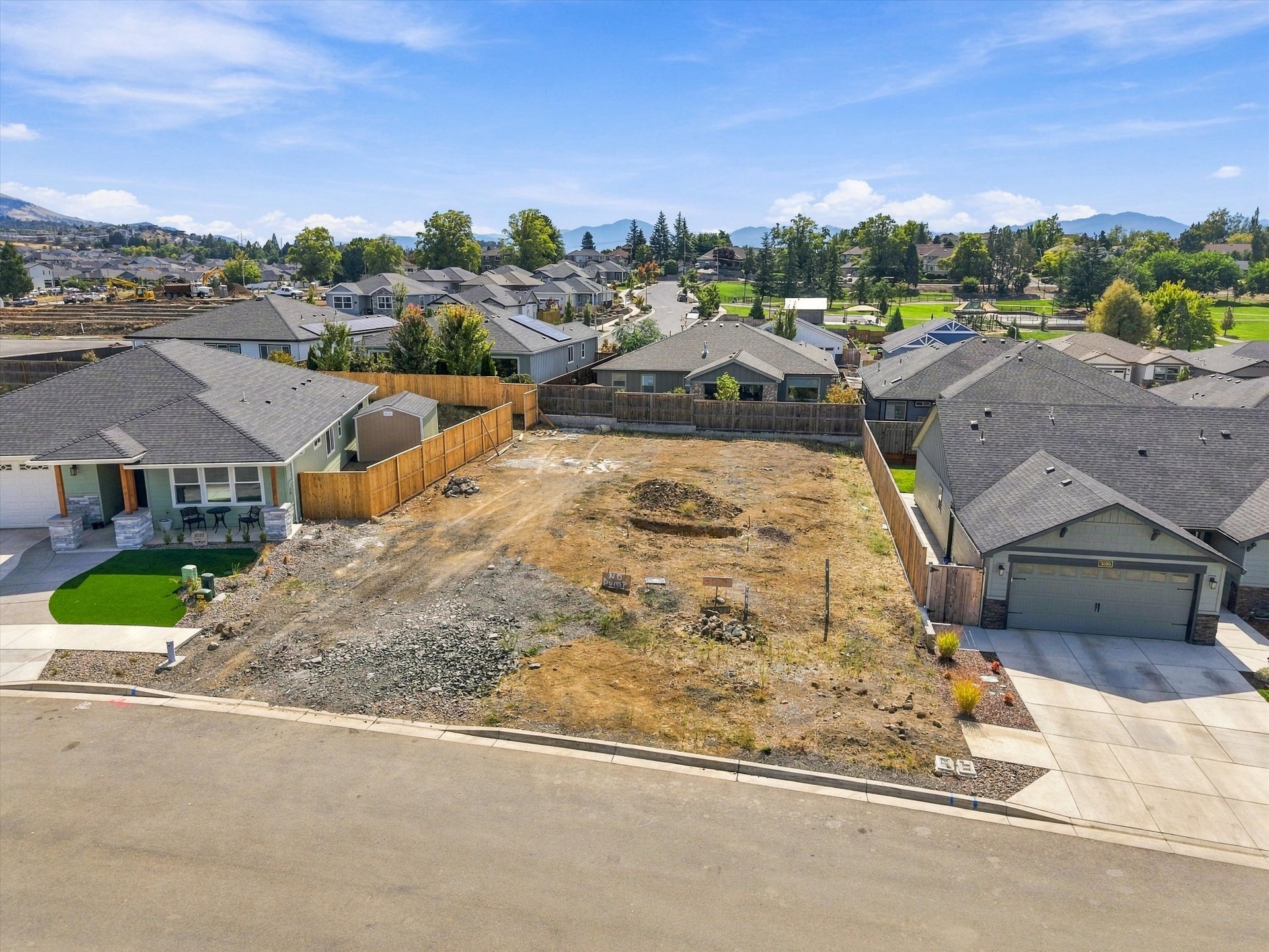 3075 Umpqua Drive, the cleared lot between two newly built homes