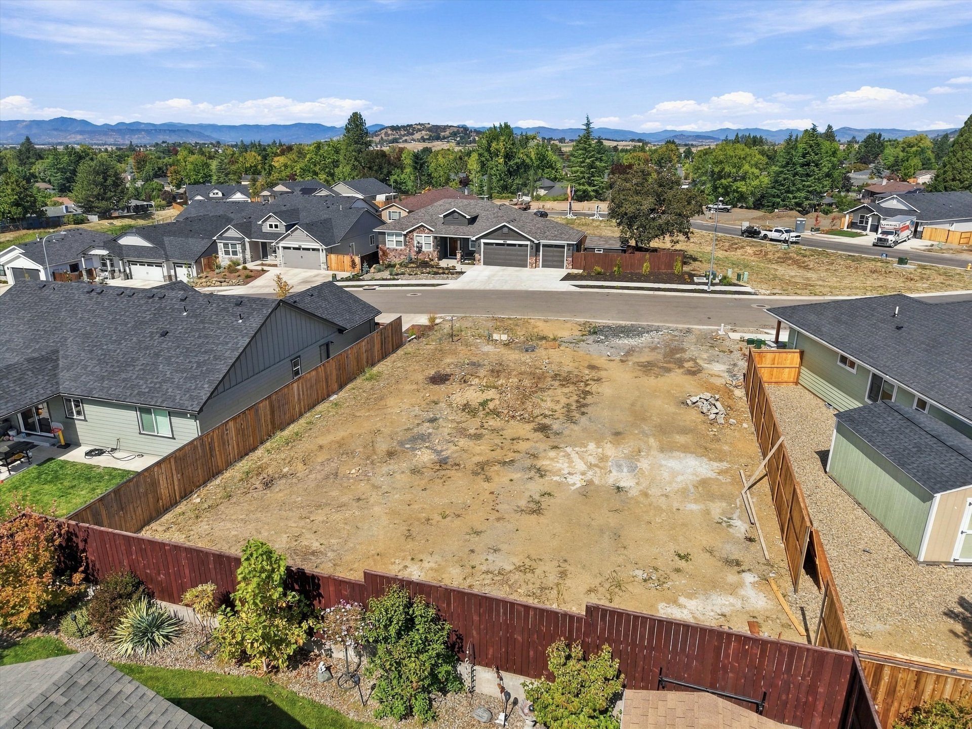 3075 Umpqua Drive, looking across the lot toward the back fence and foothills