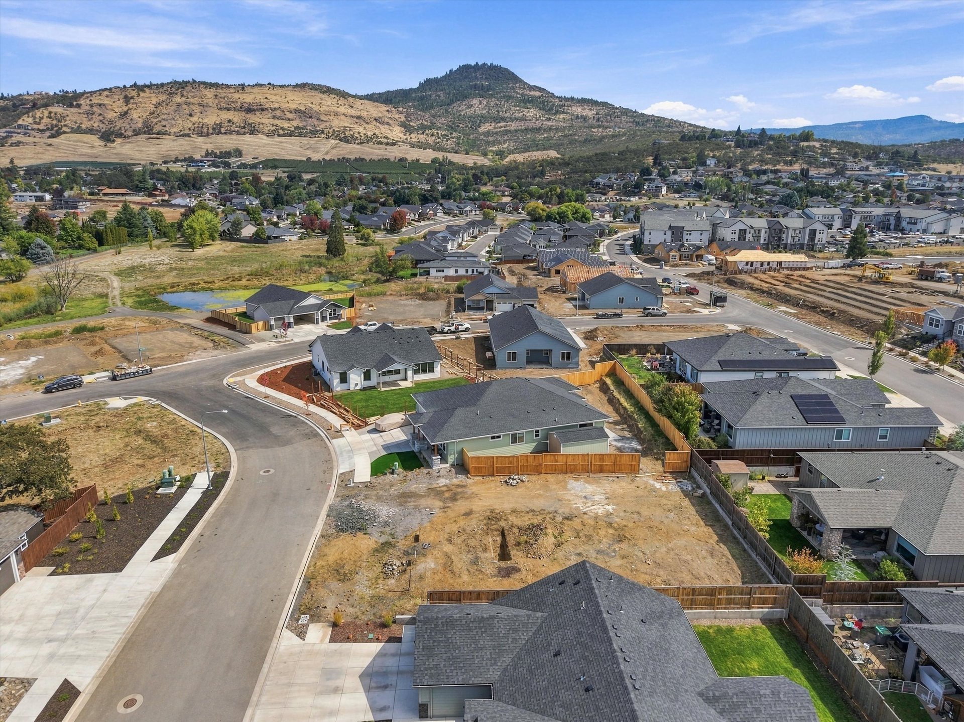 Aerial of the lot and neighboring homes with Roxy Ann Peak in the distance